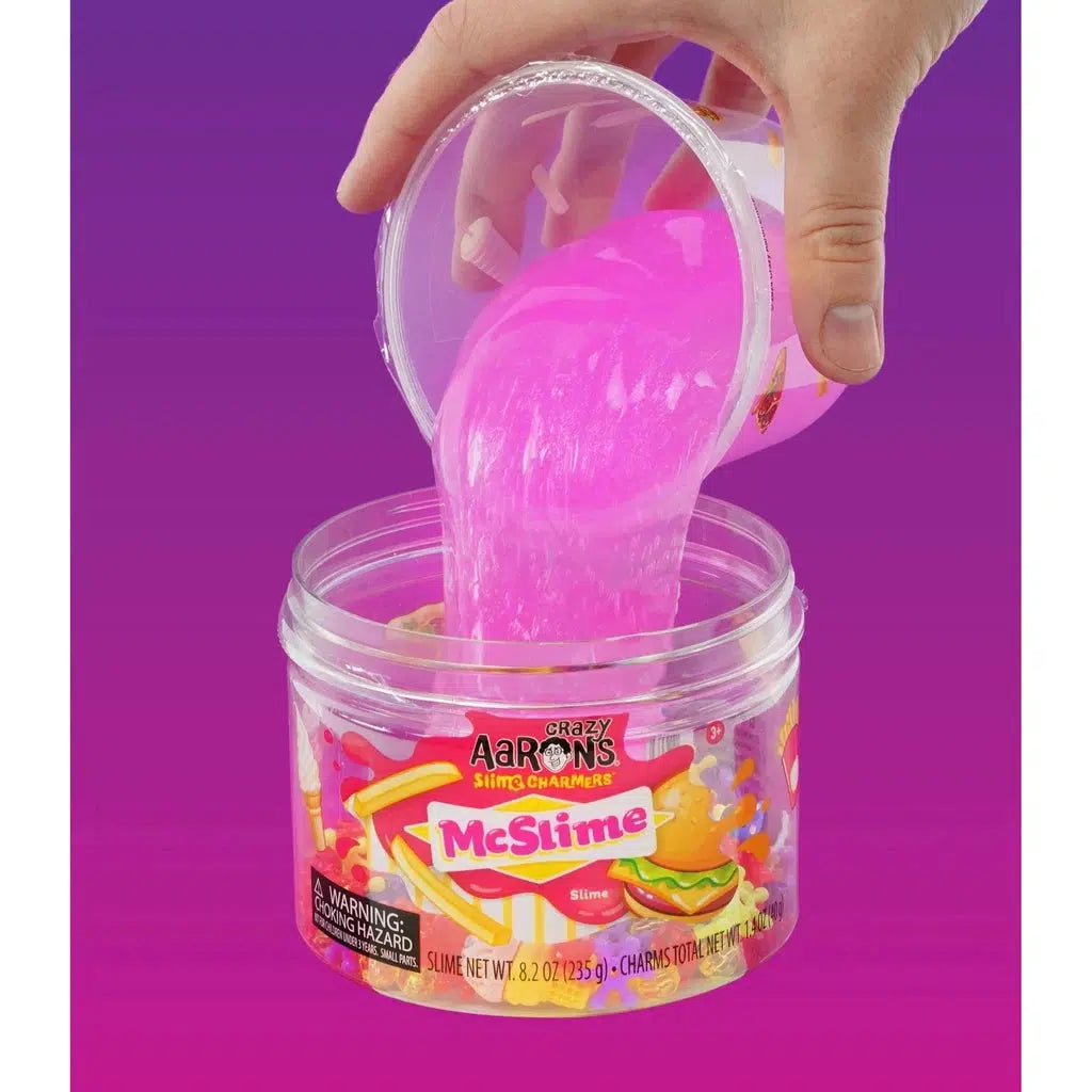 hand pouring slime into tub with charms