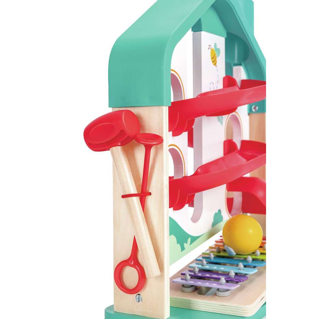 This house-shaped wooden toy includes a xylophone board and ball rolling game, featuring red mallets. Green and red parts add a splash of color.