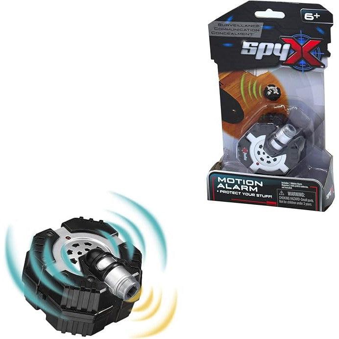 The SpyX motion alarm toy, a sleek black and silver spy gear device, is showcased both inside and outside its packaging. Designed as the ultimate spy toy for children aged 6 and up, it cleverly highlights its features to inspire young secret agents.