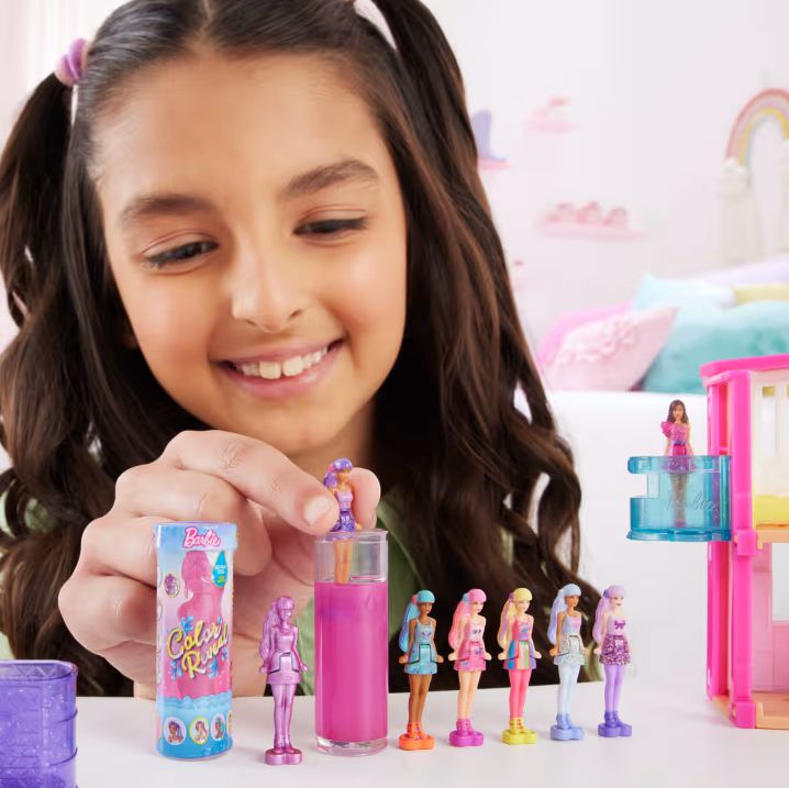 Girl playing with color reveal barbies