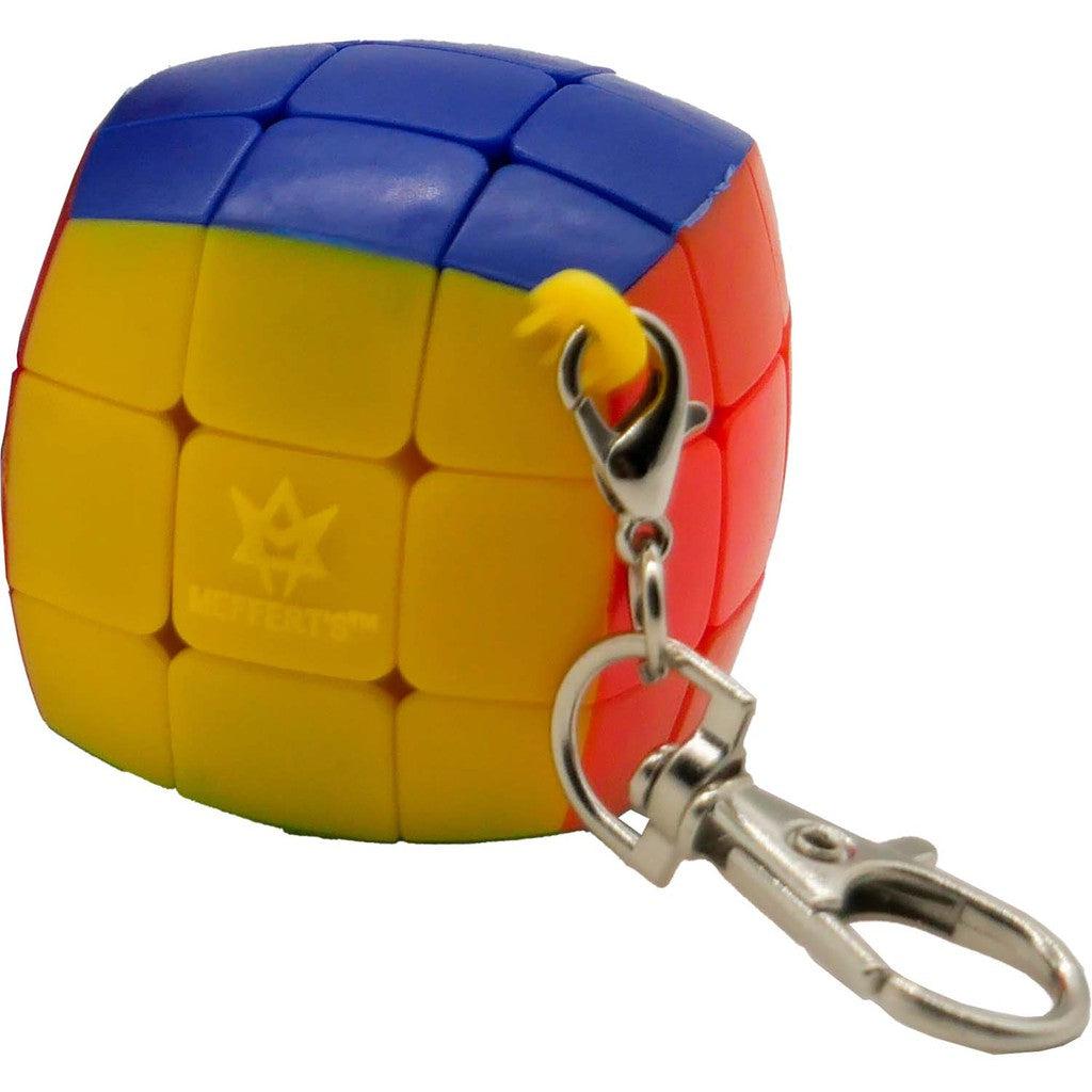 A colorful cube puzzle keychain with a metal clasp, featuring red, blue, and yellow sections.