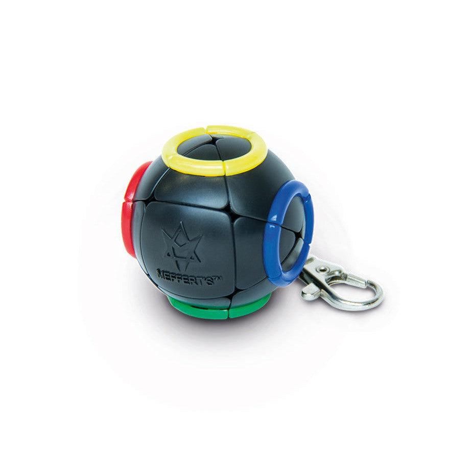 A spherical black puzzle keychain with colored rings: yellow, blue, red, and green.