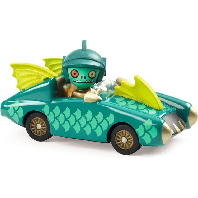 The Mister Wings toy car boasts a dragon-like design with scales and wings reminiscent of a flying fish. A helmeted figure sits inside, gripping the steering wheel. This metal car is painted green with striking yellow accents, making it a standout addition to any collection.