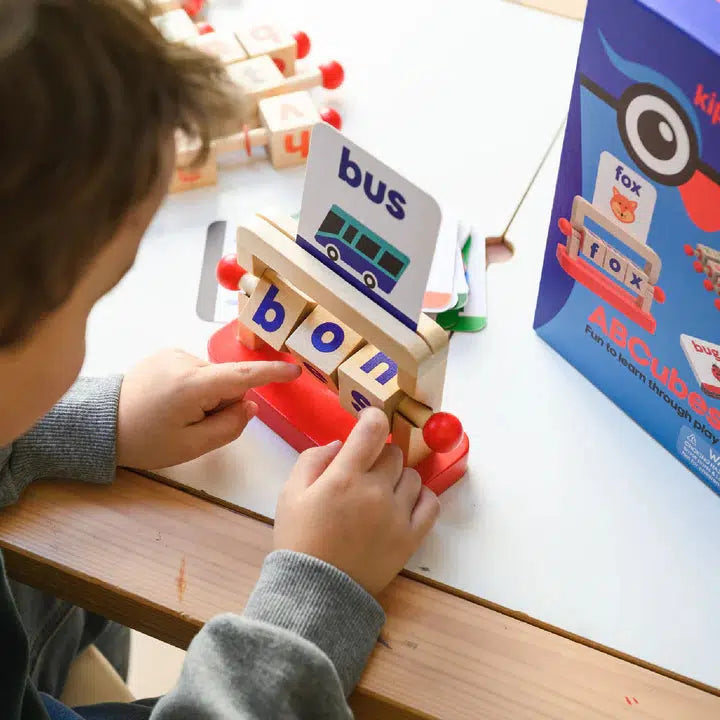 child playing with reading blocks