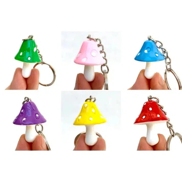 Keychains shaped like delightful mushroom key charms in green, pink, blue, purple, yellow, and red are each held between two fingers.