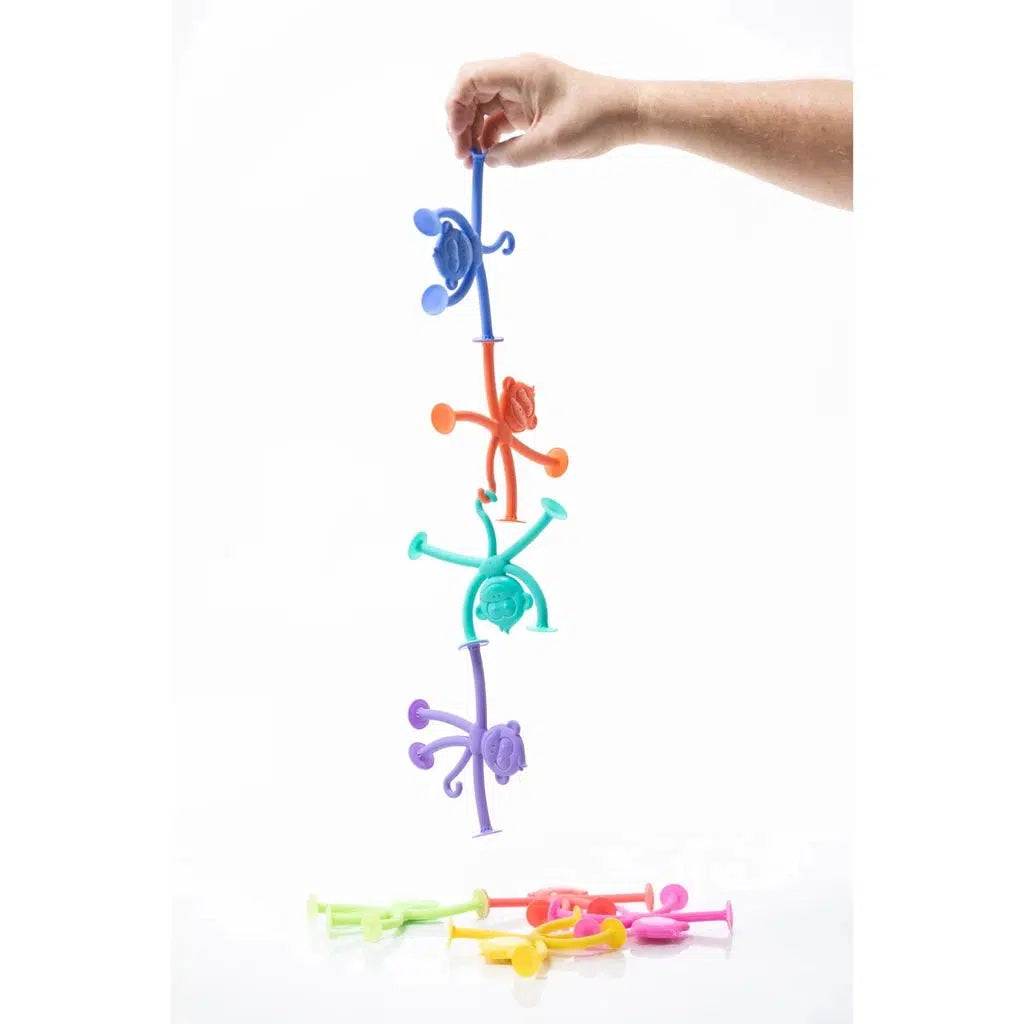 My First HangaTangs, colorful monkeys with suction cups for hands, all hanging in a string