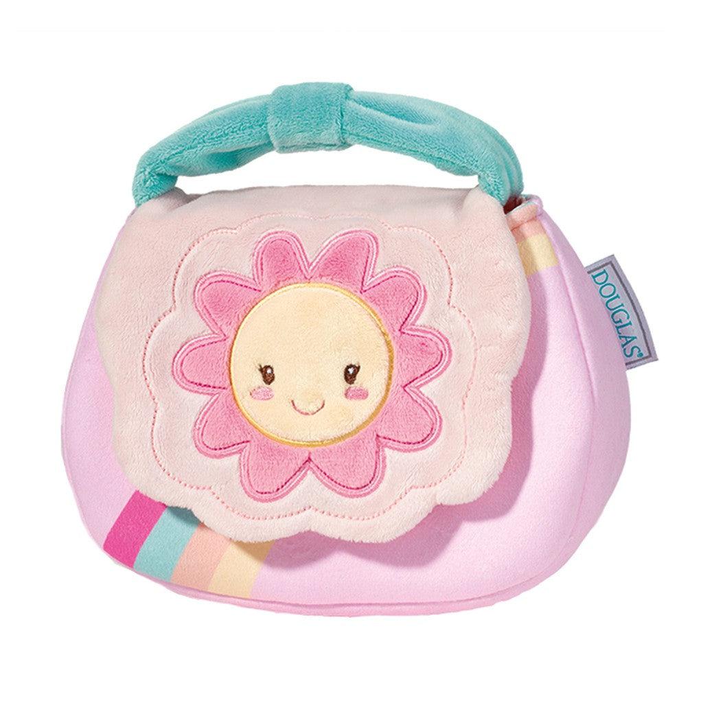 My First Purse" is a plush handbag featuring a smiling sun and pink flower design on the flap. With its pastel colors and teal handle, this delightful accessory inspires imaginative adventures for little ones who love stylish plush accessories.