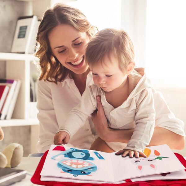 parent and child playing with book