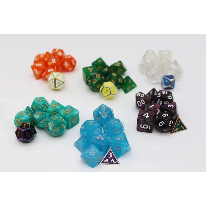 A variety of colorful polyhedral dice sets, perfect for RPG dice enthusiasts and Foam Brain fans, are displayed on a white surface. The collection includes orange, green, clear, teal, blue, and black dice.