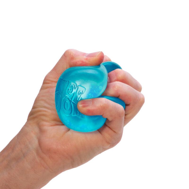 A hand squeezing a blue NeeDoh Dream Drop stress ball against a white background, creating a sensory oasis for ultimate relaxation.