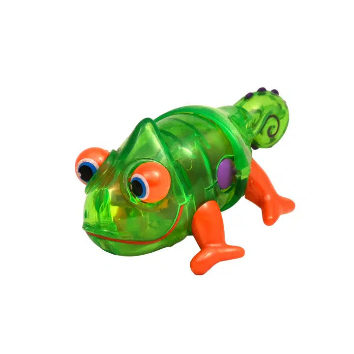 The imaginative play toy is a green and orange plastic chameleon with large eyes, a curly tail, orange feet, and a small purple spot on its side. This wind-up toy adds extra fun to any adventure as it scampers around like an animated gecko.