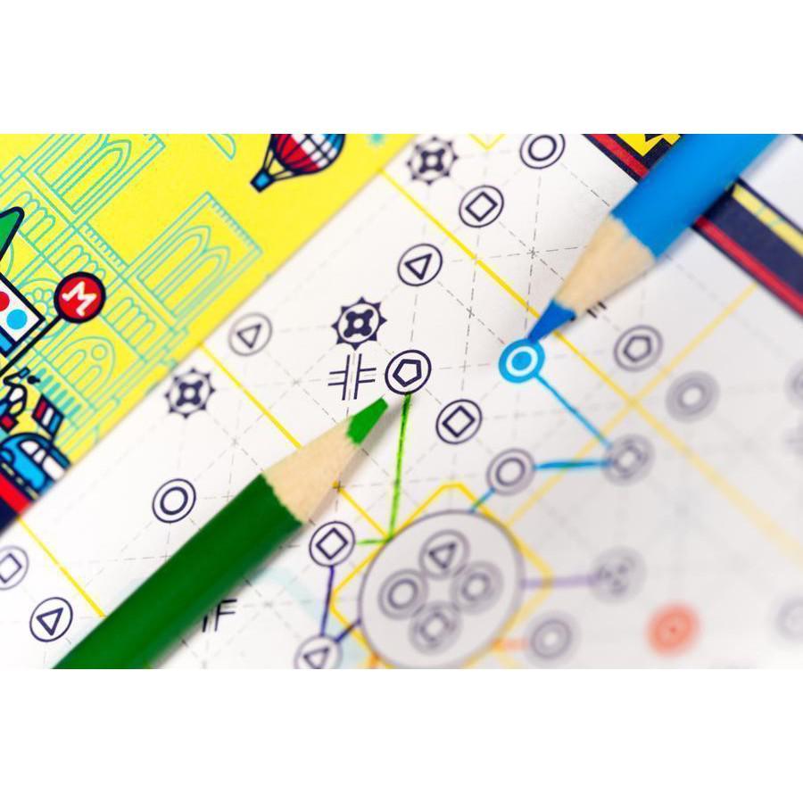 Close-up of a colorful board game map with two pencils, one green and one blue, placed on it. The map features various symbols and lines connecting different nodes.