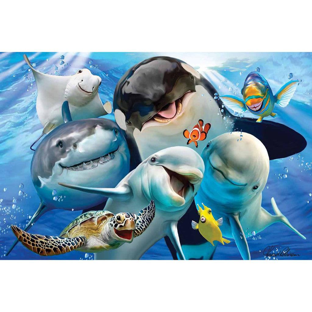 Illustration of cheerful aquatic animals, like a turtle, sharks, and clownfish, striking a pose as if for an Ocean Selfie. They swim against a bright blue ocean background.