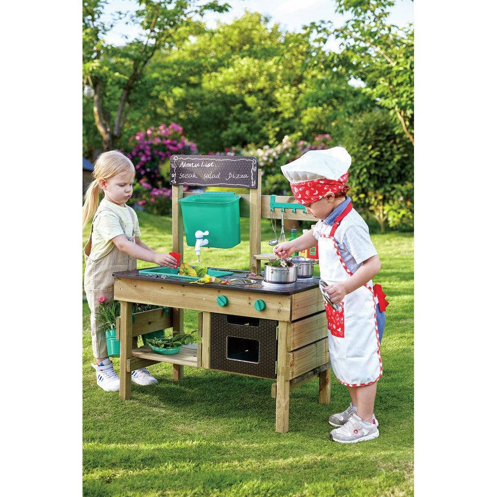 children playing with outdoor kitchen set
