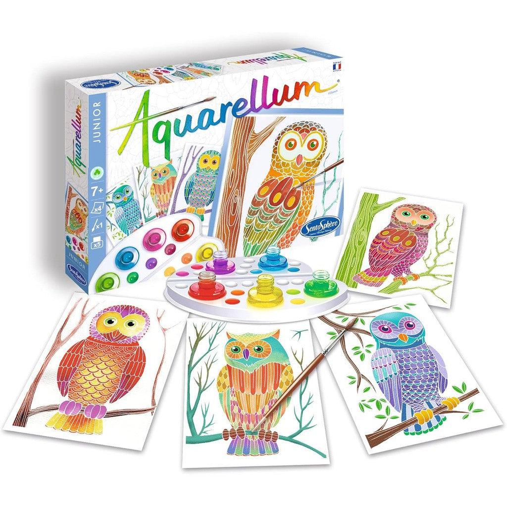 The Sentosphère Aquarellum Junior paint set showcases four vibrant owl designs, complete with a paint palette and brush, elegantly displayed next to the box. Perfect for those seeking a creative Paint-By-Number kit experience.