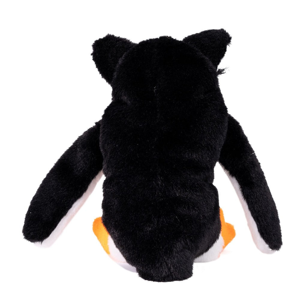 Back view of a plush penguin toy with black fur, and dog ears and orange feet 