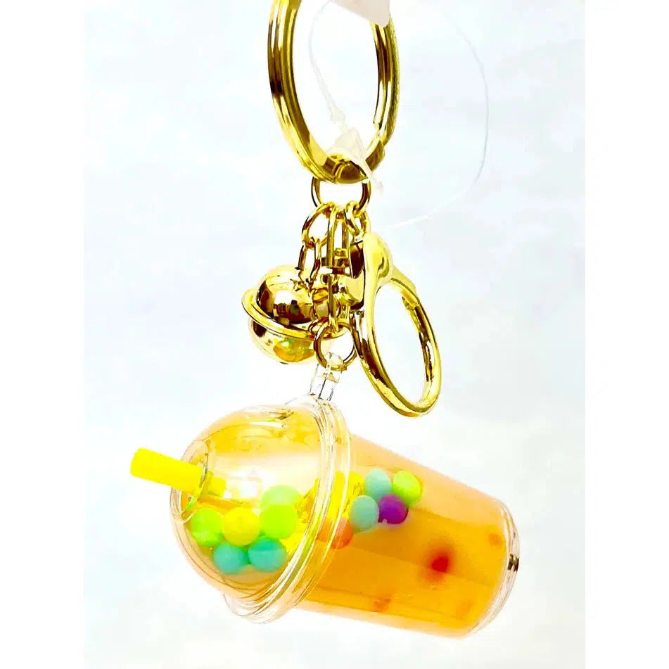 A delightful keychain charm featuring a miniature bubble tea cup with colorful beads, a yellow straw, and gold-tone metal rings and clasp. Perfect for adding a whimsical touch to your keys or bag.