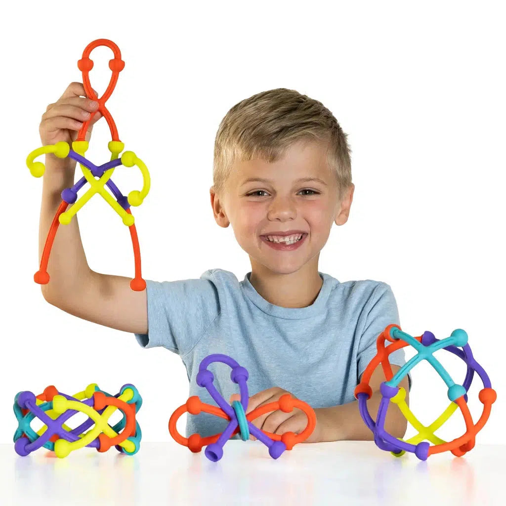 Child playing with Plip Kit, making all sorts of shapes with the silicone toys