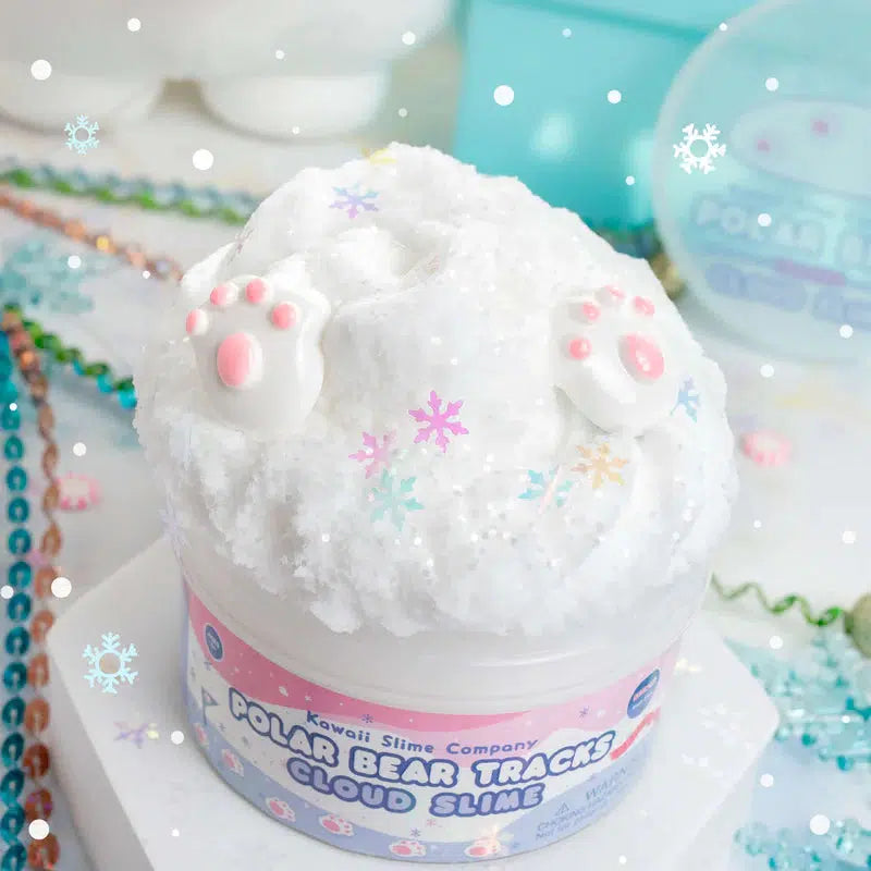 A container of Polar Bear Tracks Cloud Slime, fluffy and white with a frosty musk, adorned with cute polar bear paw designs and pastel snowflake decorations.