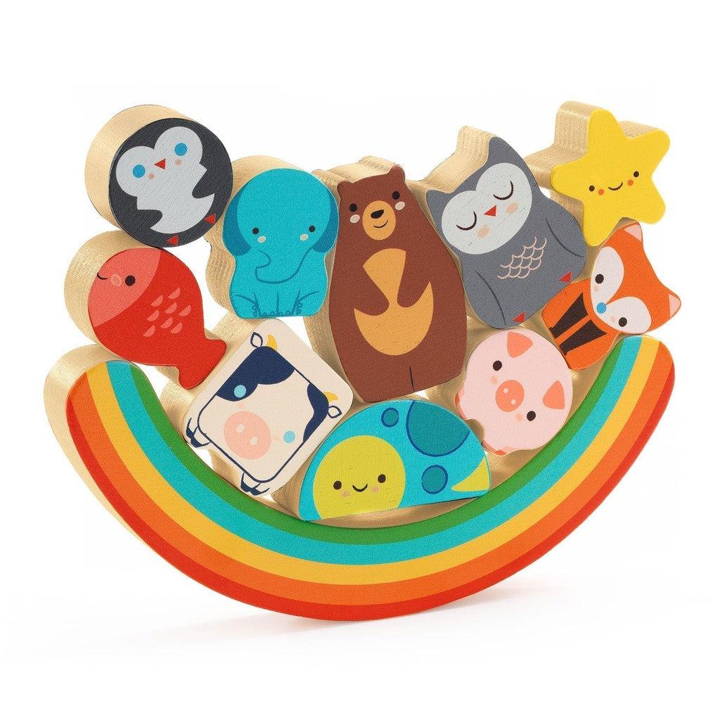 A vibrant balancing game featuring wooden animal figures, including a penguin, bear, owl, and fox, all perched on a rainbow-shaped base. This colorful Djeco Puzz &amp; Boom design delights children with its playful charm and engaging challenge.