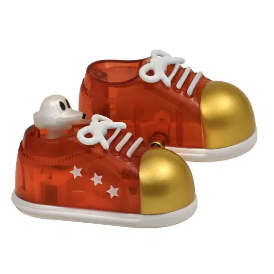 Toy plastic sneakers with gold toes and white laces, featuring a small white dog head design on top, and whimsical star patterns on the sides. These charming creations are part of the Z WindUps collection, perfect as walking shoes for your playful wind-up toy adventures.