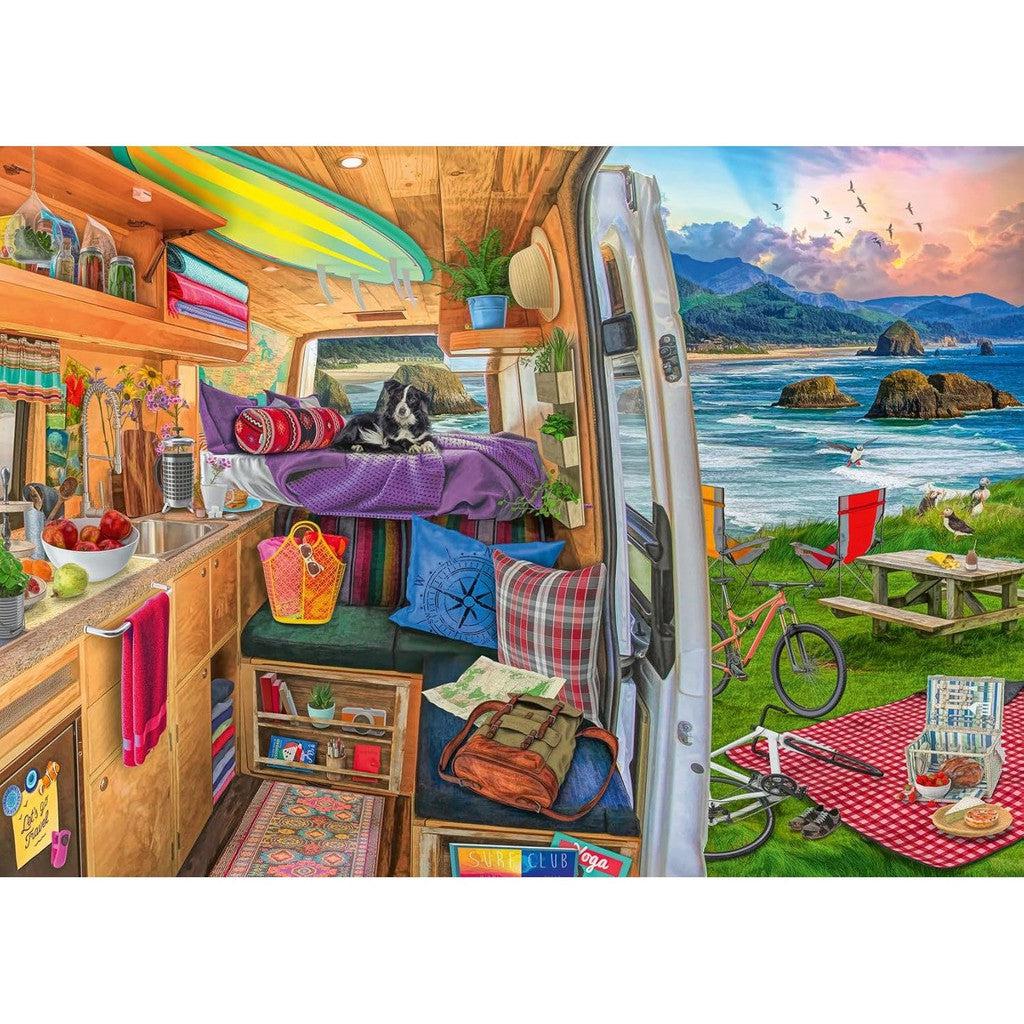 Inside a colorful camper van with surfboards and a dog on the bed, overlooking a scenic beach with picnic setup and bicycles under a clear blue sky, it's like stepping into a scene from a Ravensburger jigsaw puzzle. .