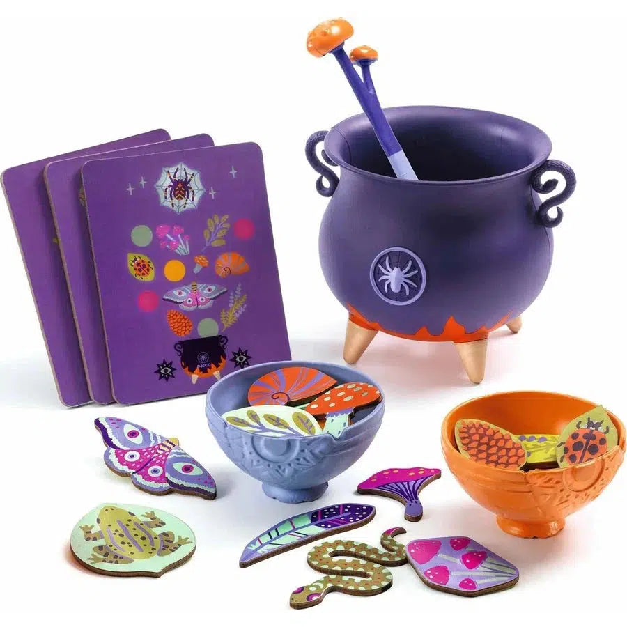 Children’s magical toy set with a purple cauldron, colorful ingredient pieces, a ladle, and recipe cards for brewing fantastic potions featuring insects and plants.