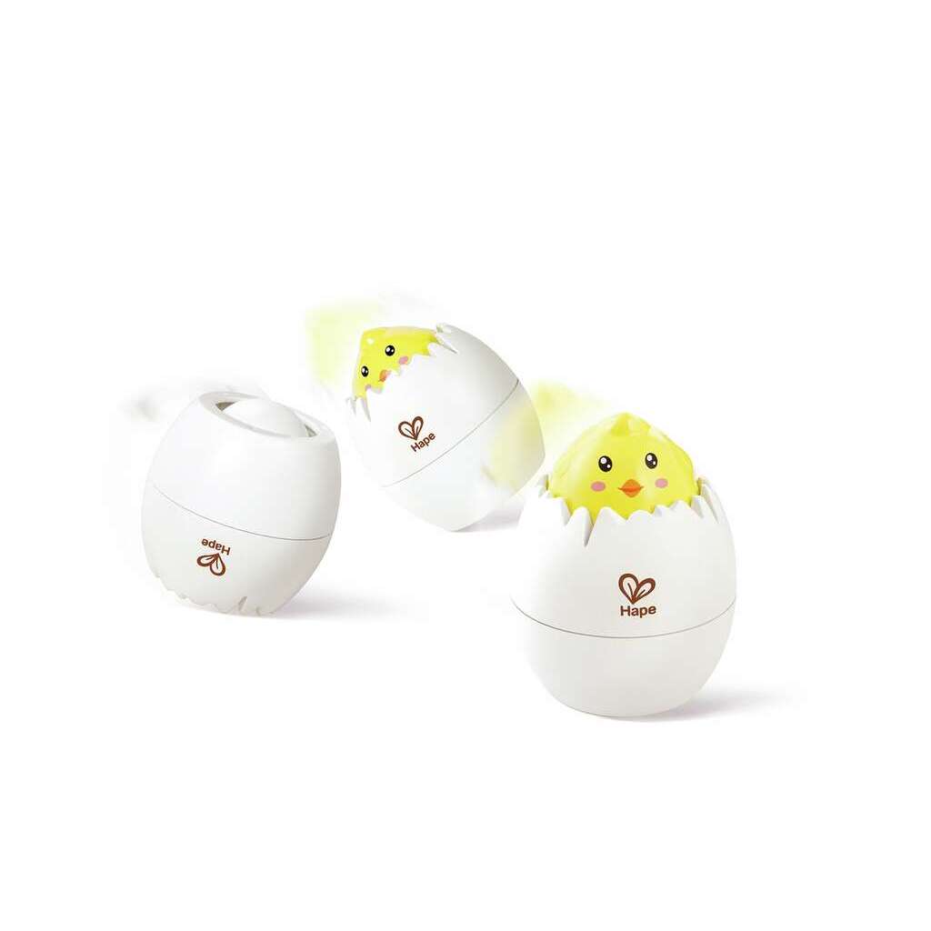 Three white egg-shaped toys, each featuring the "Hape" logo, capture a magical transformation egg moment as a yellow chick emerges. These toys not only delight but also promote cognitive growth and motor skills against a pristine white background.