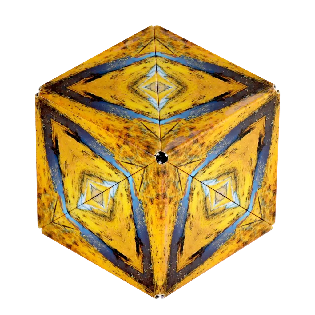 A Shashibo, this three-dimensional geometric shape transforms with triangular yellow and blue patterns on its faces, crafted using rare earth magnets.