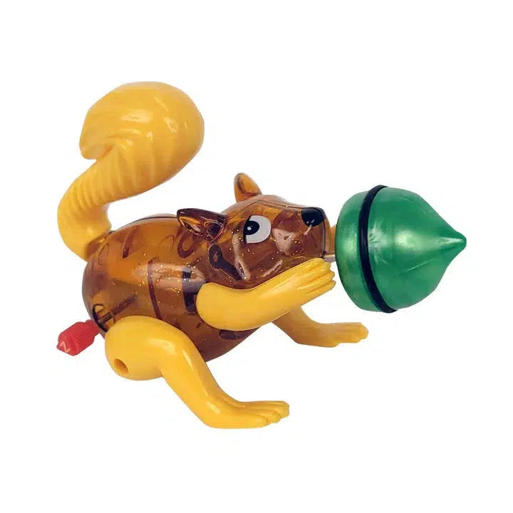 The Z WindUps Performing Squirrel is a delightful plastic toy, showcasing its acrobatic skills while clutching a green acorn with its front paws.