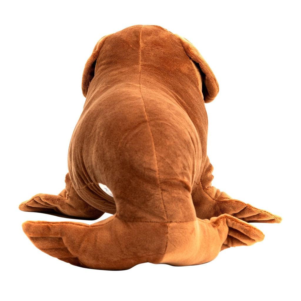 A large, brown stuffed toy resembling a hybrid animal of a dog, seen from the back, boasts floppy ears and a tail.