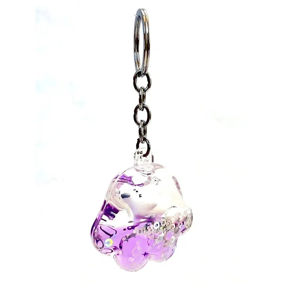 A clear keychain with purple accents shaped like a cloud, this floaty key charm features a metal chain and keyring.