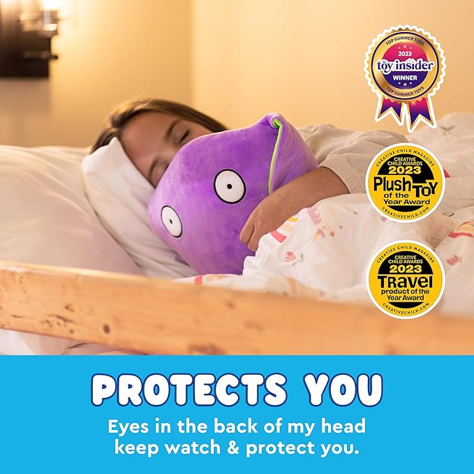 A person in bed hugs a purple Bumpas Weighted Plush Toy with eyes and the words "protects you" on it. Three award badges for 2023 are proudly displayed, showcasing the charm of this Cute Cuddle Pal.