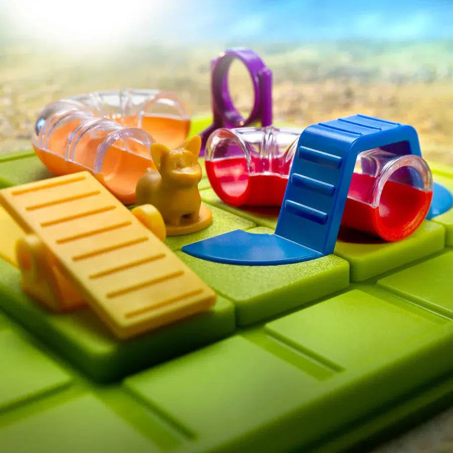 The colorful toy maze on a green board features clear tunnels, ramps, and an exciting obstacle path, complete with a small animal figure to engage young minds.