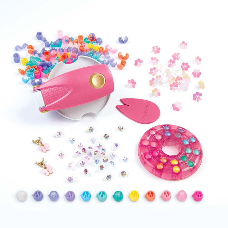 Discover the Make It Real Snap 'N Glam Hair Styling Set, featuring a vibrant bead kit complete with colorful beads, a pink bead applicator, and a round storage case. This playful set transforms creativity into fun-filled hair styling adventures.