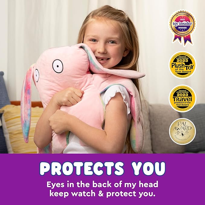 A girl cuddles a large pink bunny plush toy with big eyes, her favorite Bumpas. Various award badges are displayed in the corner. Text reads: "Protects You – Eyes in the back of my head keep watch &amp; protect you.