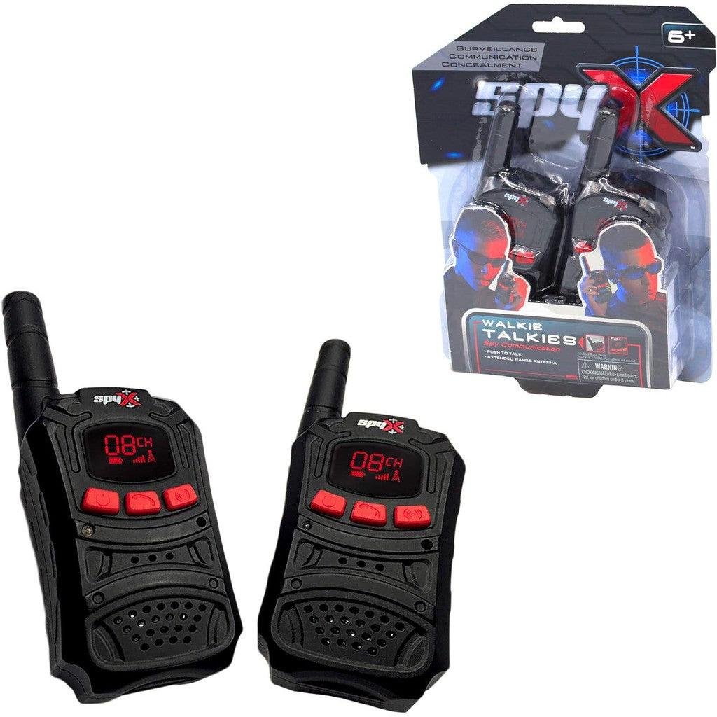 Two Spy X walkie talkies with a sleek black and red design, perfect for any Spy Gear Collection, are displayed next to their packaging. Ideal for young agents ages 6 and up.