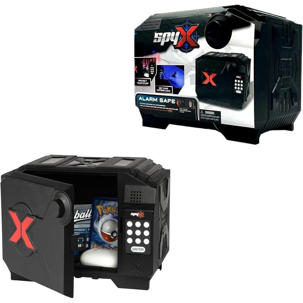 A SpyX alarm safe, black with a red "X" design, is shown open and closed. The open safe contains a Pokéball and other small items, perfect for aspiring Spy Kids. The packaging box is visible in the background.