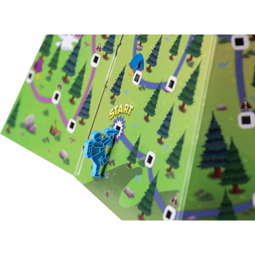 Close-up of the Goliath Summit or Plummet Game featuring a START marker and a path through a green forest landscape. The journey is punctuated by 3D mountains, where a blue game piece eagerly begins its adventure through trees and squares designed for strategic movement.