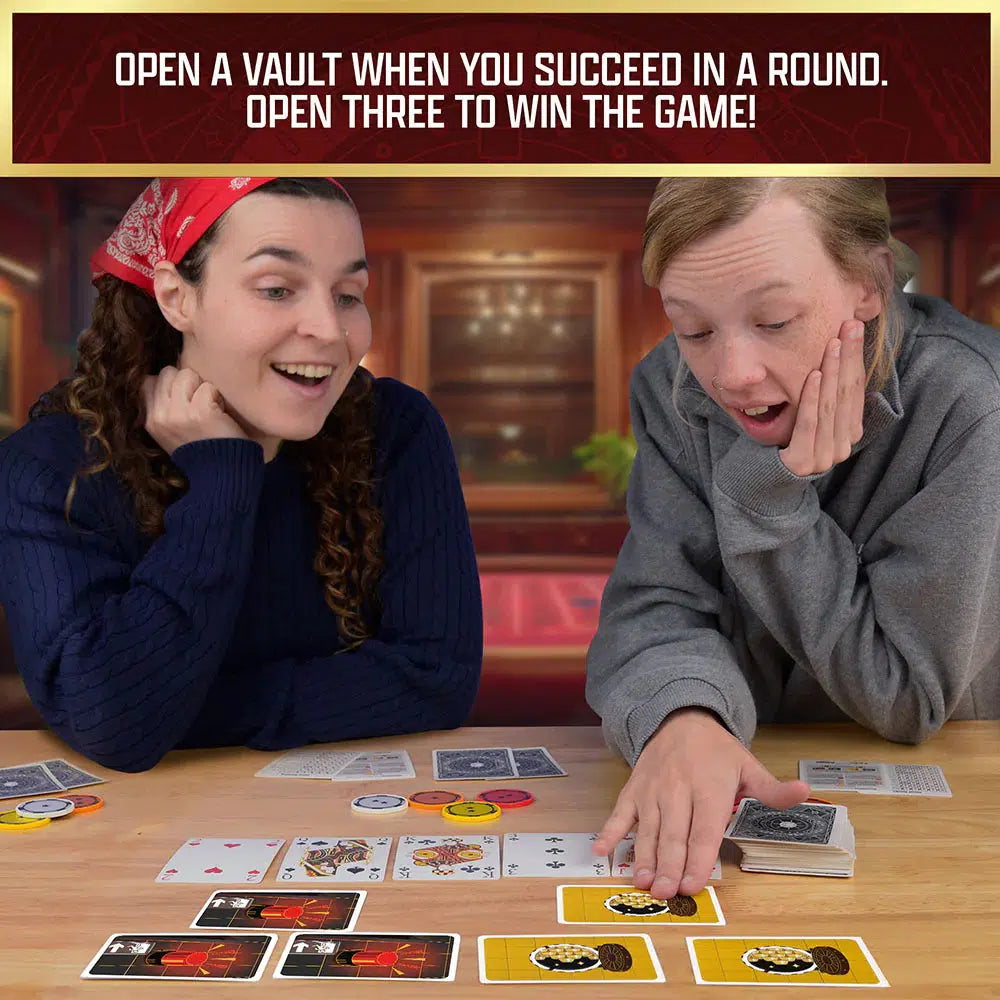 Two people sit at a table engrossed in a cooperative card game. The person on the right looks surprised, while the one on the left smiles mysteriously. Cards and coins scatter across the table, hinting at an intricate heist unfolding between them.