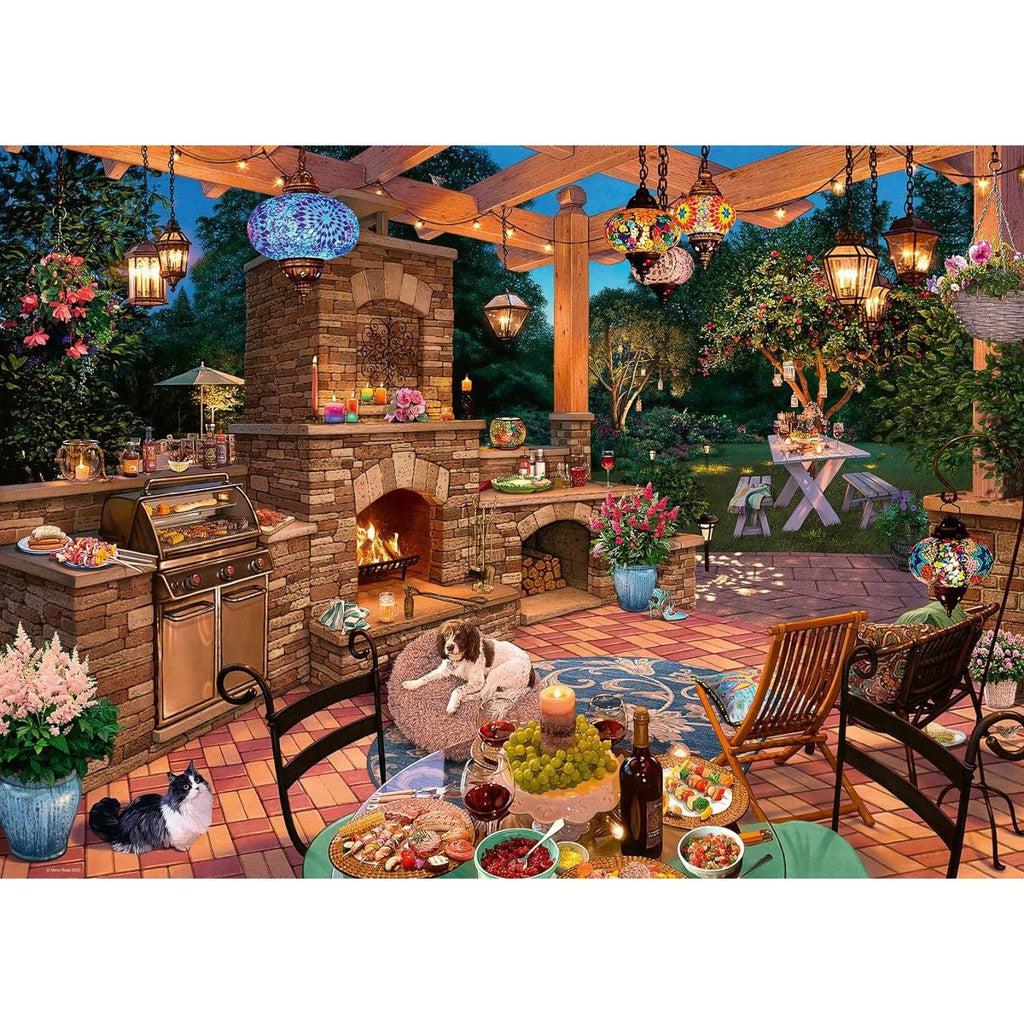 A vibrant outdoor patio scene unfolds like a Ravensburger The Garden Kitchen jigsaw puzzle, complete with a brick fireplace, grill, and a table laden with food. Lanterns hang above as two dogs frolic amidst lush trees and flowers—a picture-perfect 1000-piece delight.