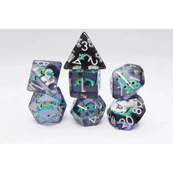 A set of clear polyhedral dice, perfect for role-playing games, displaying small colorful lizards inside—a fantasy twist reminiscent of vibrant koi ponds.