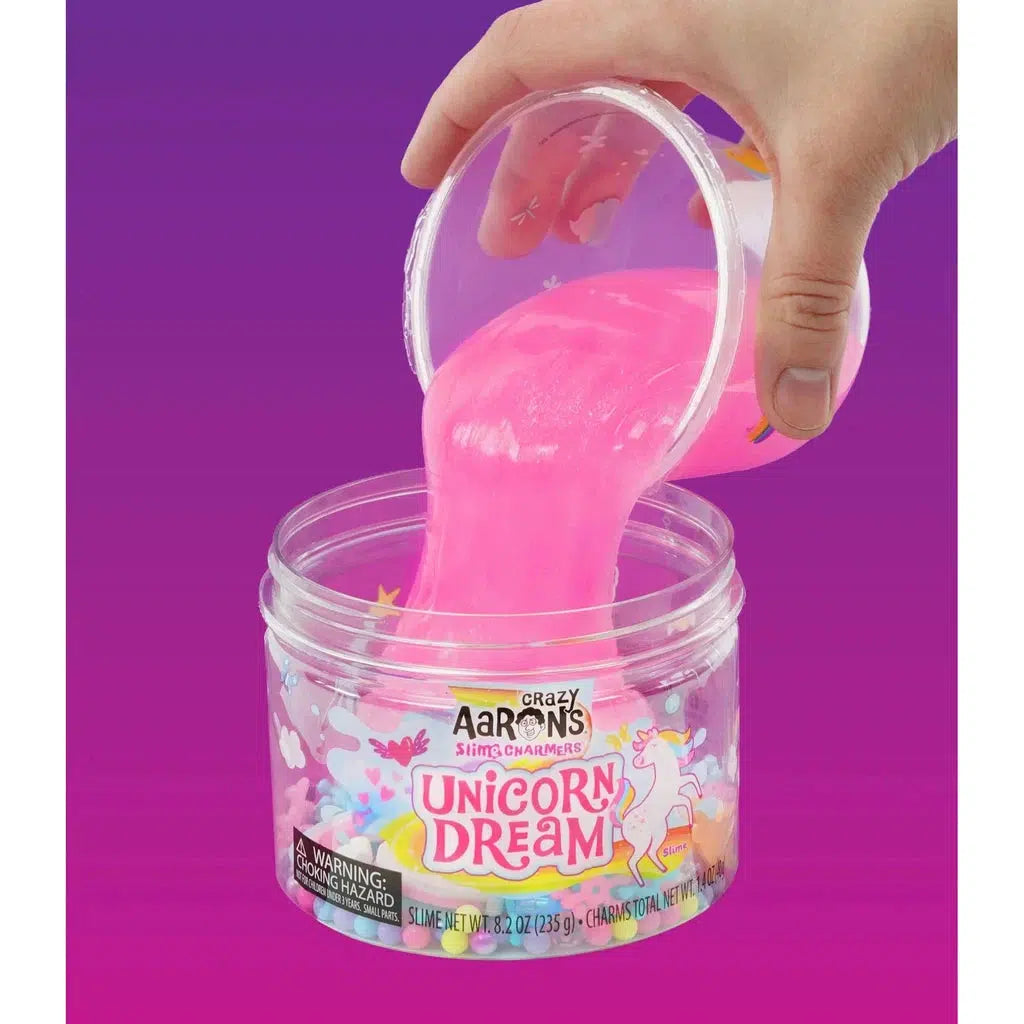 hand dumping slime into tub of charms