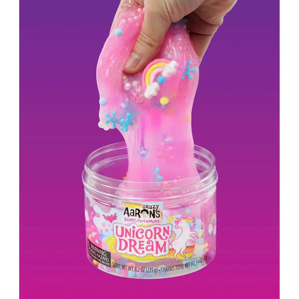 hand playing with slime filled with charms