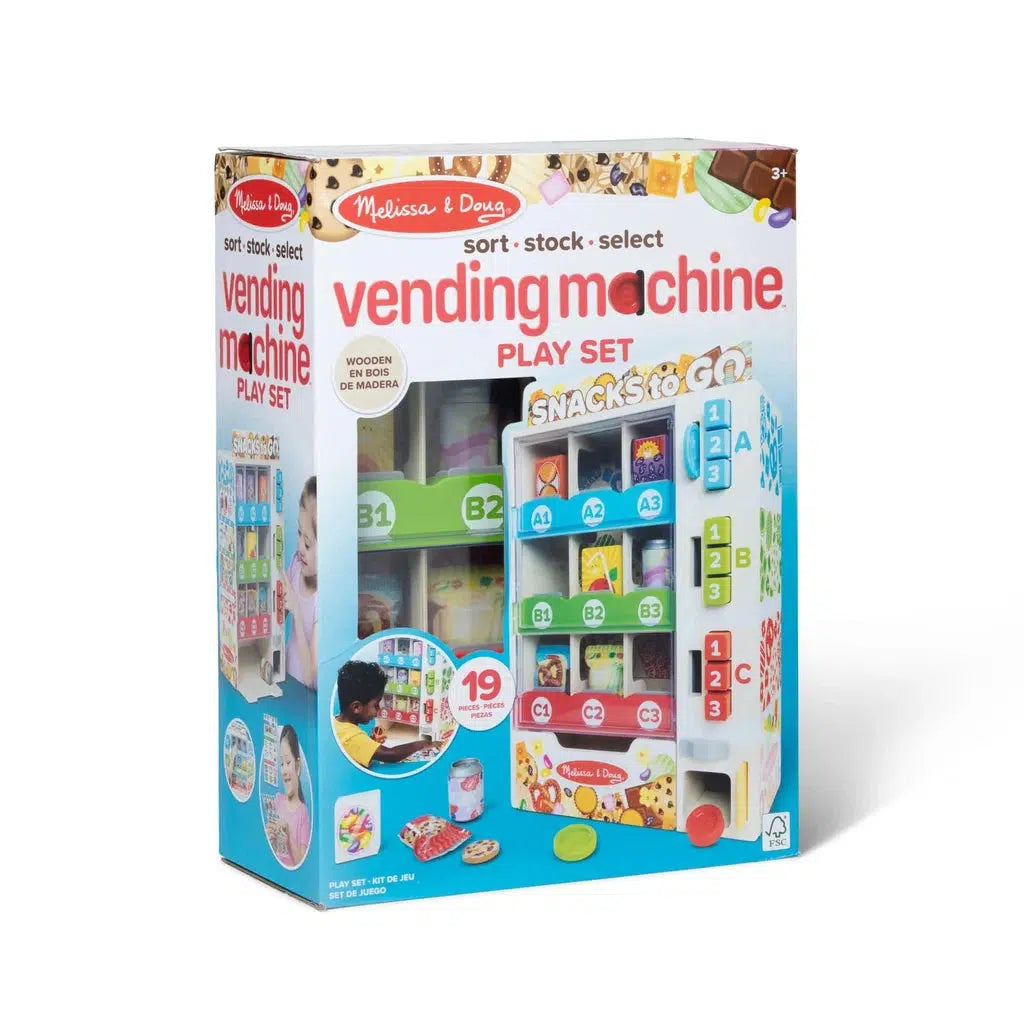 The box features a Melissa &amp; Doug wooden vending machine play set, complete with vibrant play snacks and color-matching play coins. Perfect for imaginative fun, it includes various play food packages to enhance your child's learning experience with numbers and colors.