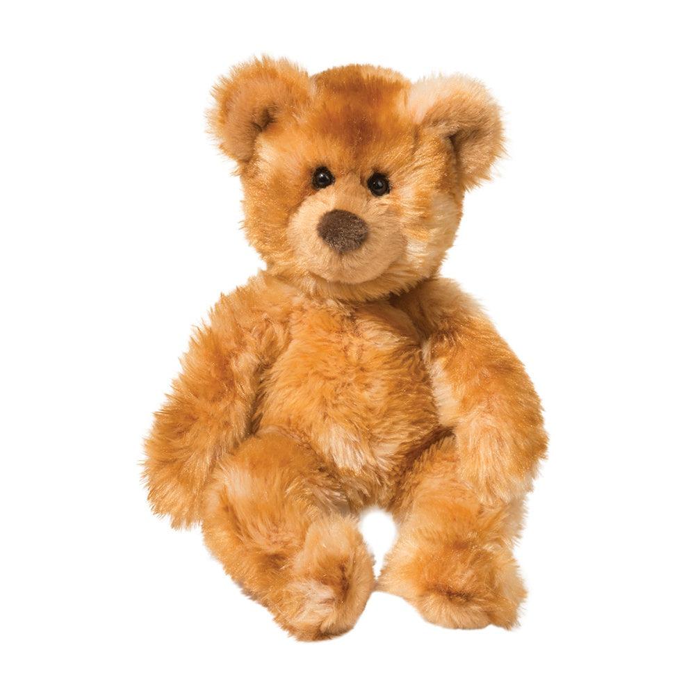 Waffles Cinnamon Bear is a small fluffy teddy bear. Classic style with small eyes and a nose, he is a few shades of brown that ombre into each other.