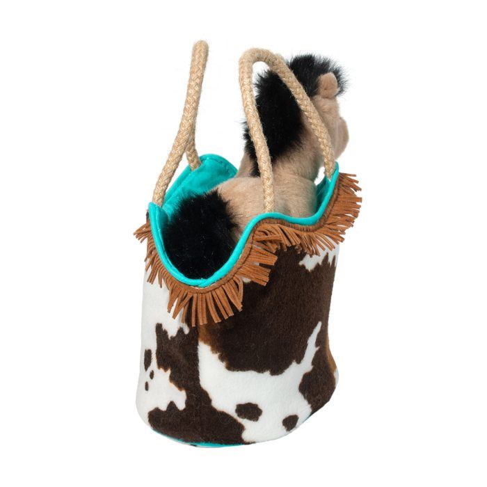 The Plush horse toy comes nestled in a Western Sassy Pet Sak, featuring a brown-and-white patterned bag with rope handles and fringe trim, making it the perfect cowgirl accessory.