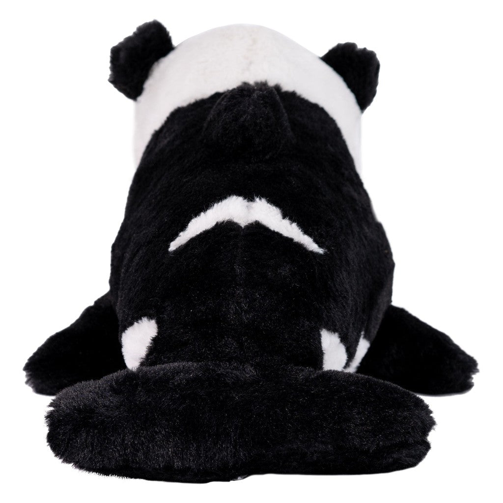 Plush toy of a black and white panda bear/whale mix, viewed from the back.